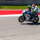 Me, on the back of a very fast MotoAmerica Superbike, trying not to focus on the fact that two people were balancing on one wheel at this point in time. Photo credit: Kurt Bradley
